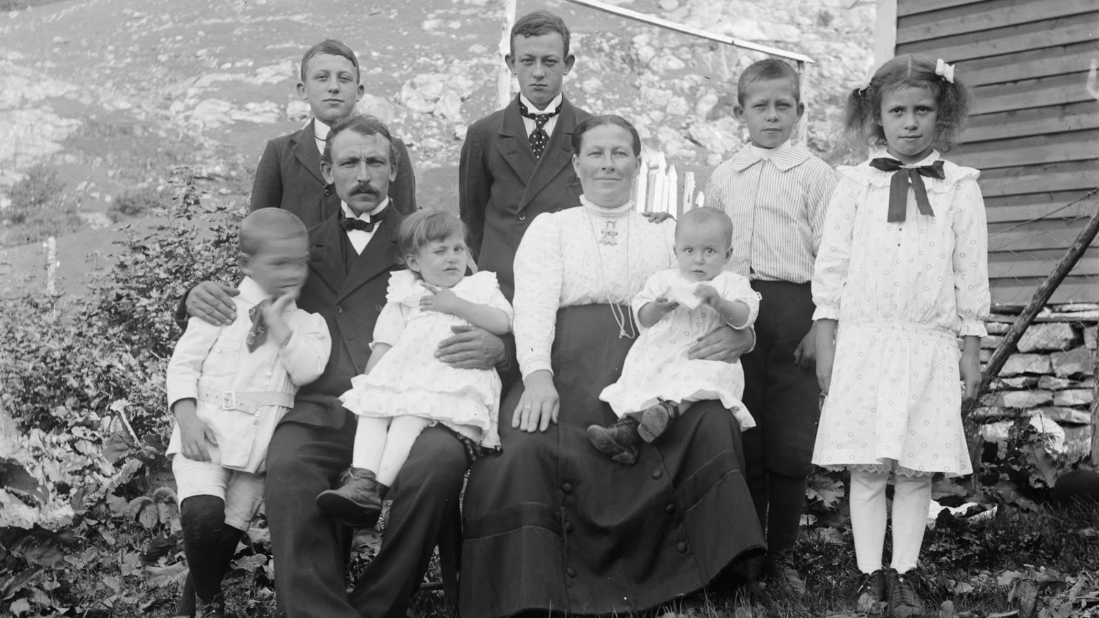 A restored black-and-white family portrait of parents and children